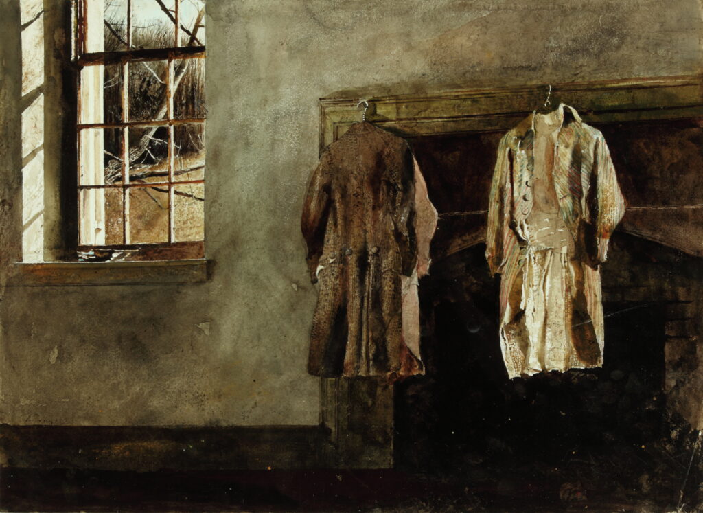 Two antique quaker coats hang near a sunny window.